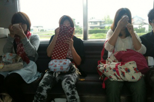 Girls doing their make-up on the train in Japan
